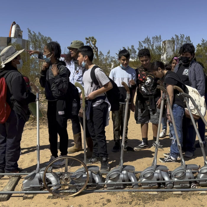 Maria Myrick, UAI project coordinator, leading middle schoolers on a tour of the Outdoor Museum in 2022.